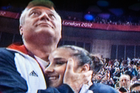 Coach hugs Aly in joy