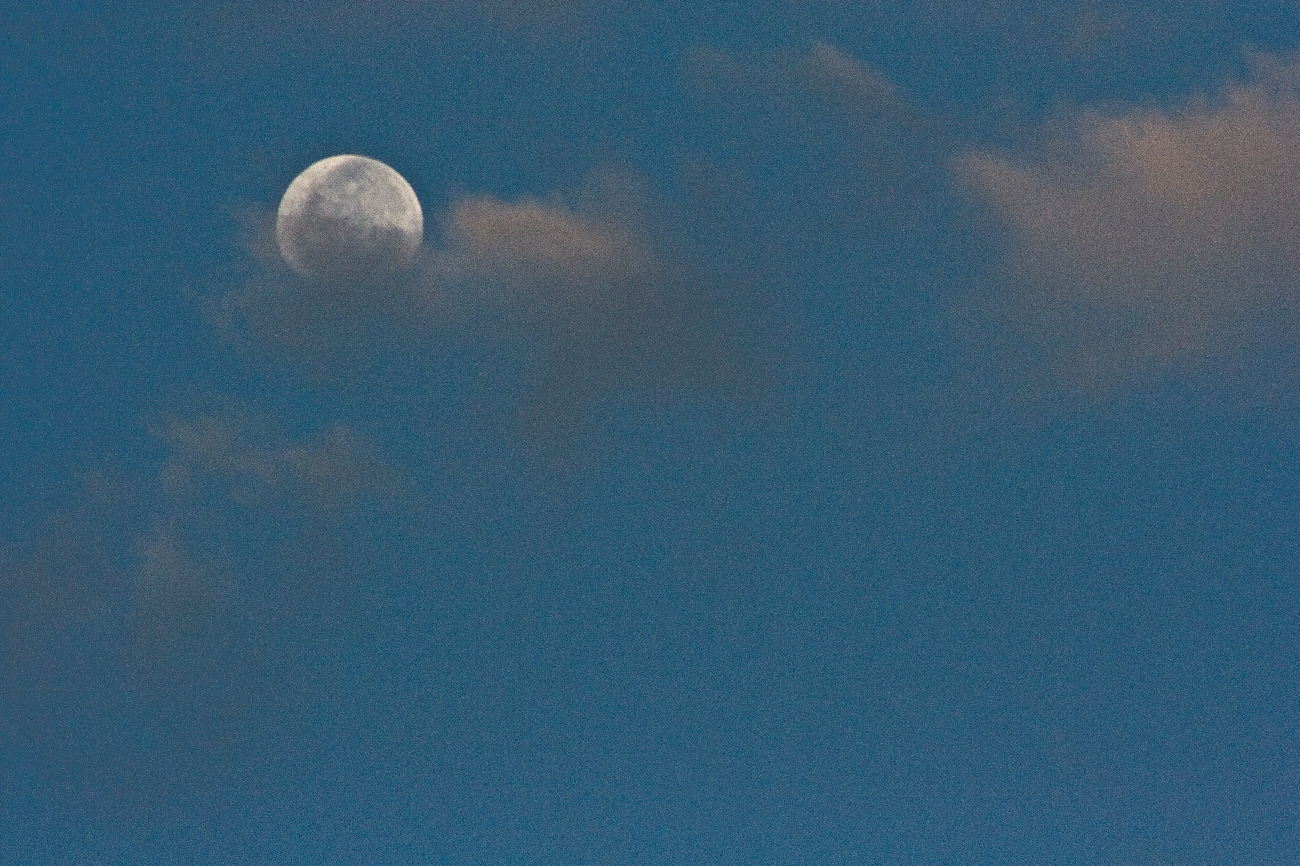 Moon, half cloud-veiled