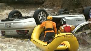 Rescue boat approaches overturned car